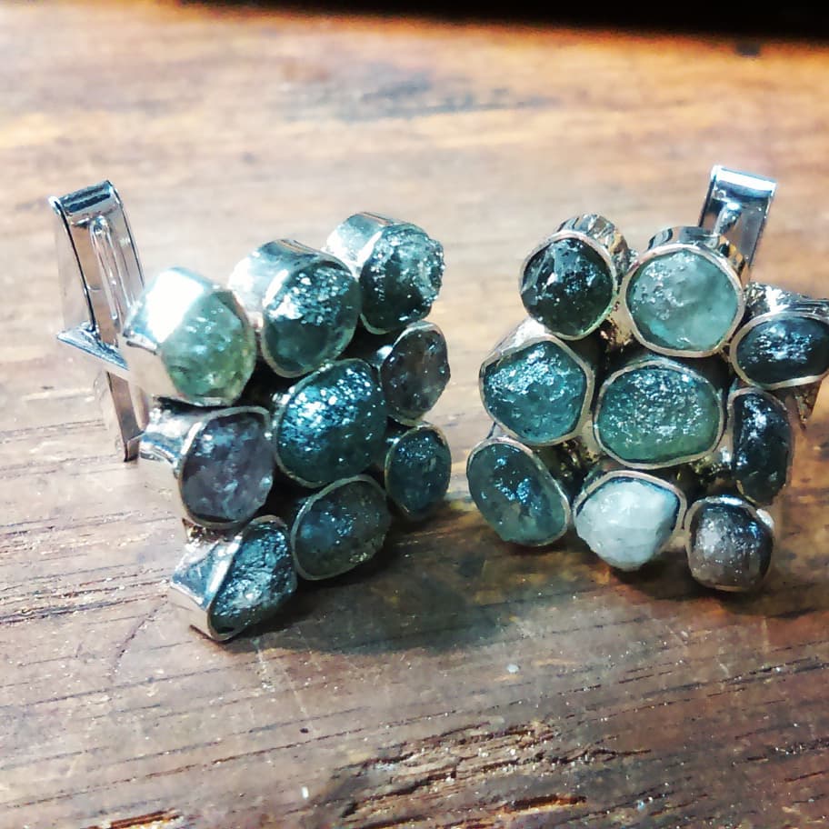 14k white gold cufflinks featuring bezel set rough uncut multi-color natural sapphires.