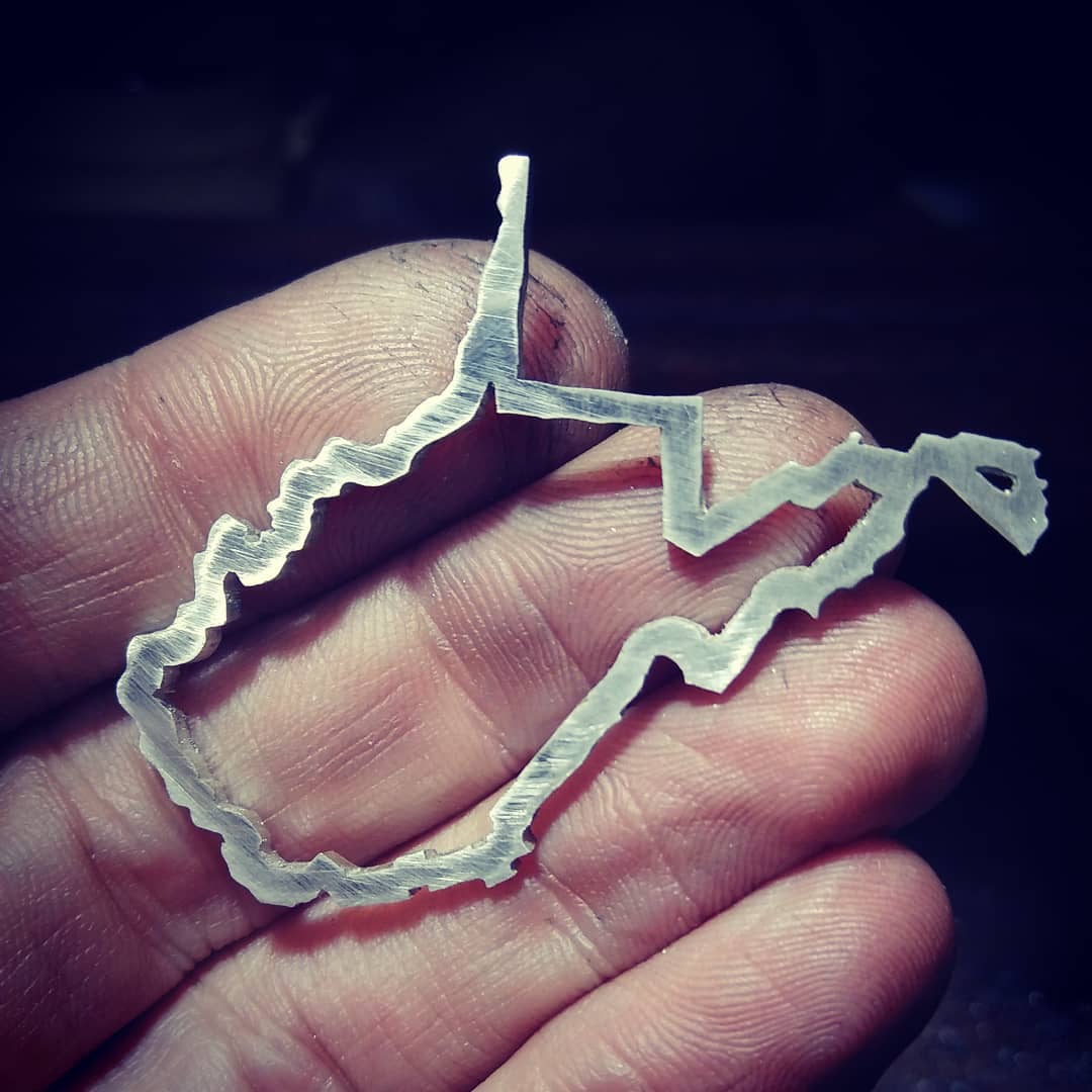 Sterling silver West Virginia state outline brooch.