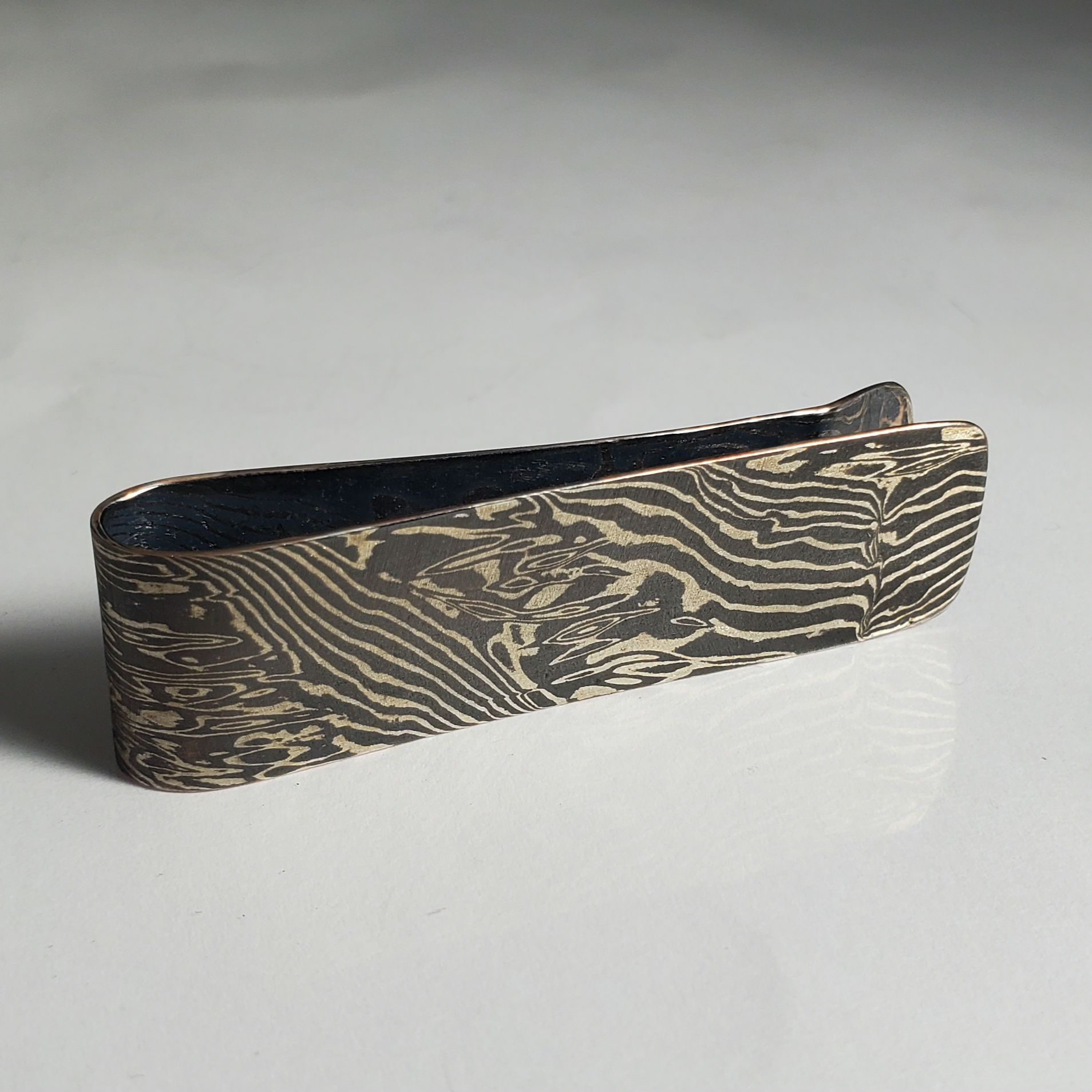 Copper and sterling silver woodgrain style money clip.