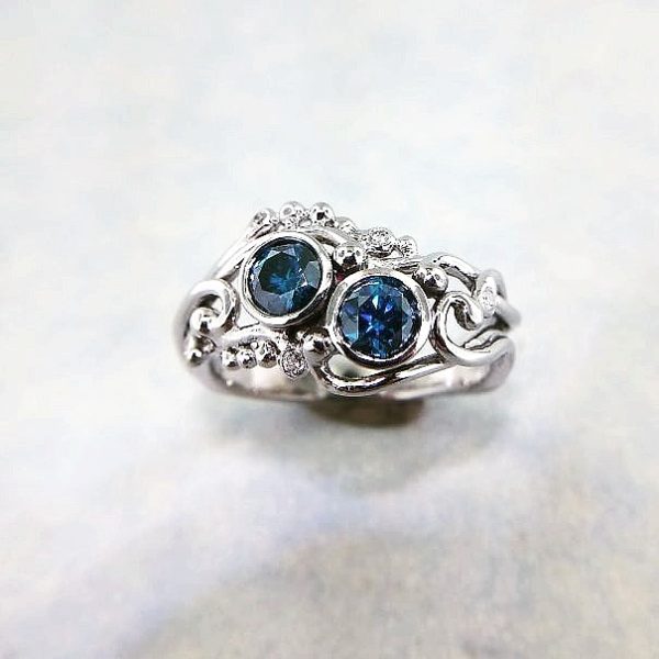 Two round blue diamond's set in 14k white vine detailed band, and more accent diamonds throughout, hand crafted alternative engagement ring.