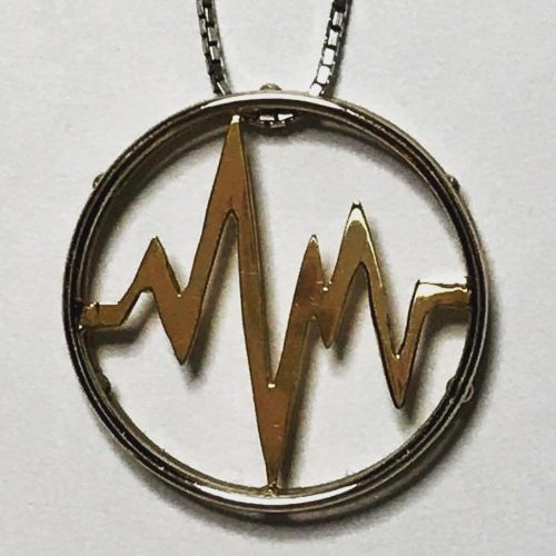 Hand cut 14k yellow gold heartbeat set in a sterling silver circle slide pendant.