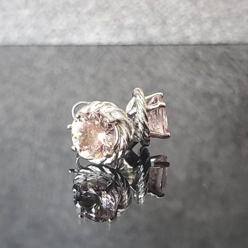 Round pink diamonds prong set in 14k white gold with twisted accents.