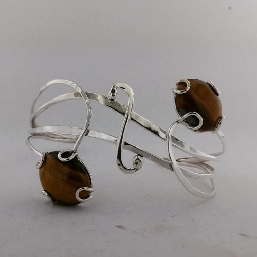 Organic twisted sterling silver cuff with vines holding tiger eye stones.