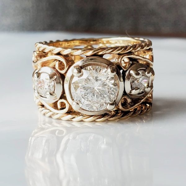 Three Star-129 round diamonds are prong set in a bold rope and filigree design.