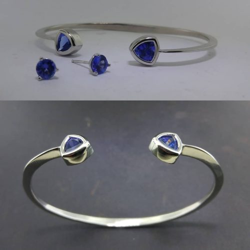 Two bezel set trillion cut blue tanzanites, on each end of a 14k white gold cuff.