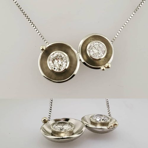 2 bezel set round diamonds set in 14k white gold pods with yellow gold bead accents.
