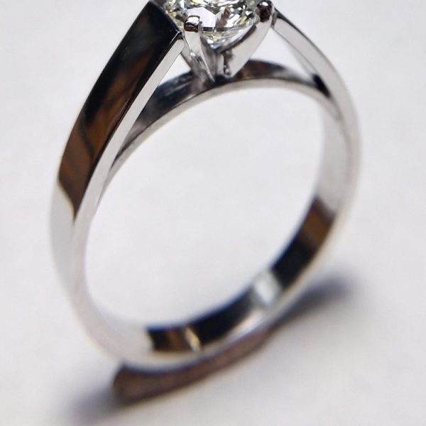 Bright white diamond prong set and mounted on a 14k white gold cathedral band, a classic engagement ring style. Item 1012