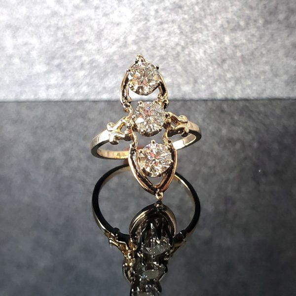 14k yellow gold antique style ring with three round old European cut diamonds.