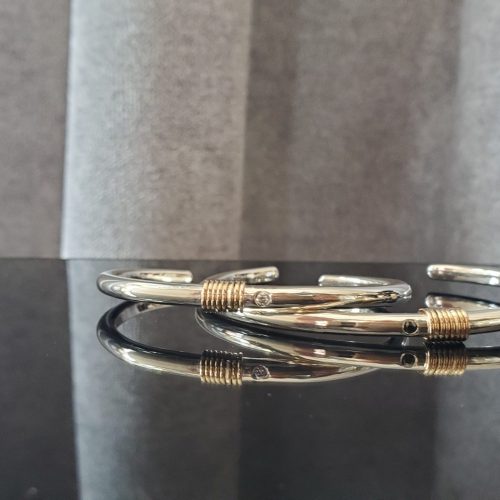Sterling silver cuff bracelets with twisted 14k yellow gold wire centers.