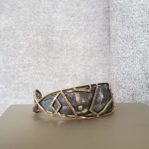 Molten and blackened sterling silver set in 14k yellow gold cuff, with hammered gold geometric accents.