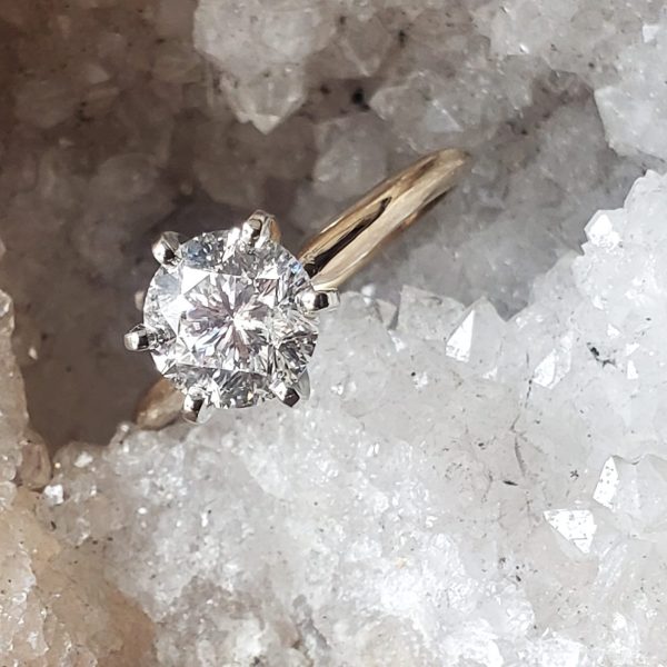 A gorgeous classic engagement ring with a round diamond prong set in 14k white gold, on a 14k yellow gold band, simple solitaire, classic style. Item 1002