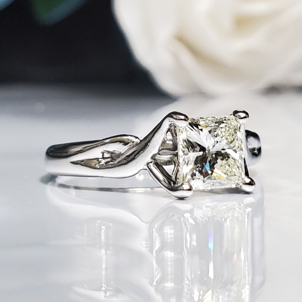 Princess cut white diamond, prong set in a twist cathedral style 14k white gold band, classic engagement ring. Item 1009