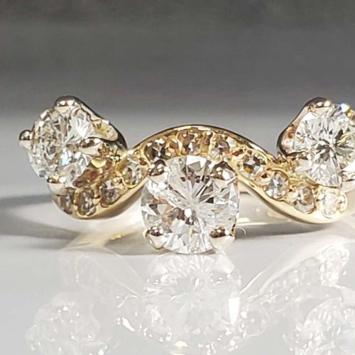 Three stone ring with diamond accents in 14k yellow gold. Designed by John Kuehn. Made in Morgantown, West Virginia USA