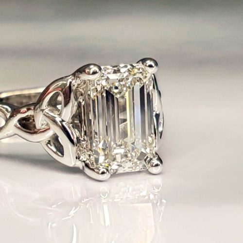 Infinity style Celtic knot engagement ring prong set with an emerald cut diamond. Created by Katherine Spencer. Made in Morgantown, West Virginia USA