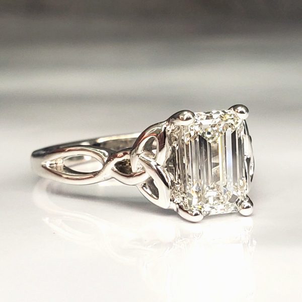 Emerald cut diamond prong set on a 14k white gold band with Celtic Knot accents, engagement ring, customized, unique. Item 1015