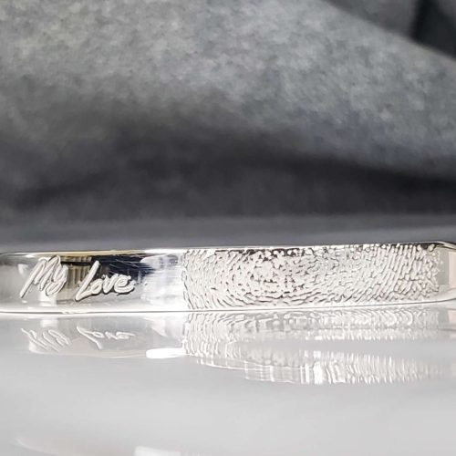 Hand fabricated sterling silver hinge tension bracelet, with flattened top, engraved with handwritten note and fingerprint.