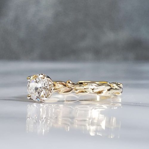 Dainty carved leaf and vine prong set diamond solitaire engagement ring in 14k yellow gold with tiny diamond dew drop accents. Created by Katherine Spencer. Made in Morgantown, West Virginia USA