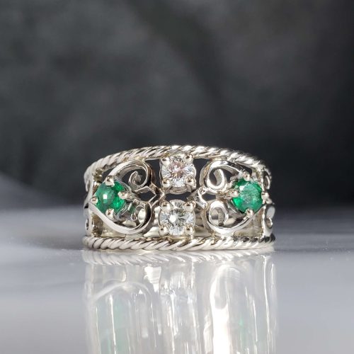 Filigree style band ring with rope edges and prong set round diamonds and emeralds. Made by Katherine Spencer in Morgantown, West Virginia USA