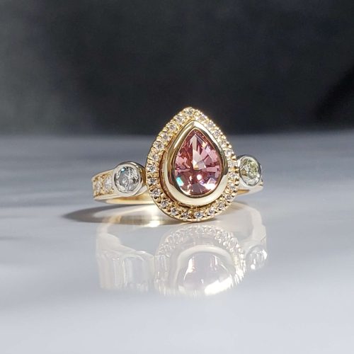 Bezel set morganite and diamond 3-stone halo ring in 18k yellow gold with a diamond accented band. Created by Katherine Spencer. Made in Morgantown, West Virginia USA