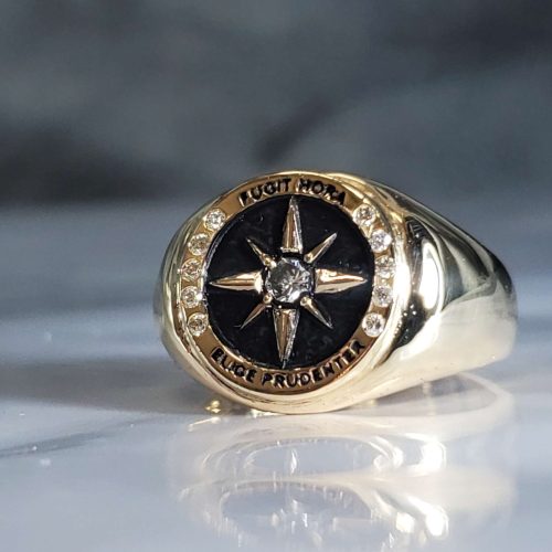 3D engraved compass signet ring in 14k yellow gold with diamond accents and black enamel. Designed by John Kuehn created by Katherine Spencer. Computer work by Charlotte Levinson. Made in Morgantown, West Virginia USA