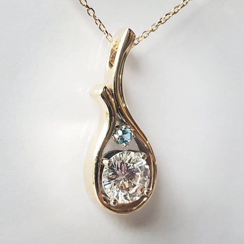 Large cabochon green turquoise with hints of gold flecks, is prong set in a bubbly and earthy 14k yellow gold setting with a sturdy bail.