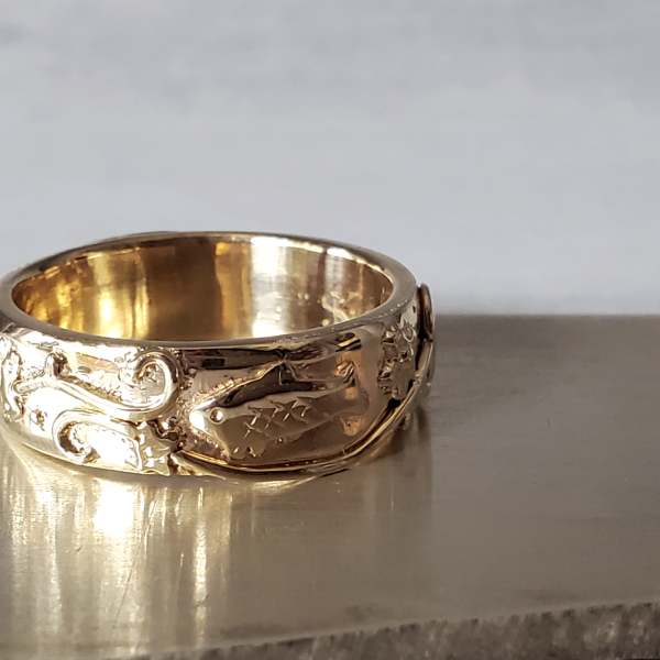 hand carved fish and underwater men's wedding band in 14k yellow gold. Created by Katherine Spencer in Morgantown, West Virginia, USA