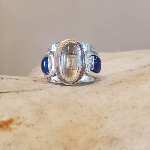 Pear shaped diamond with diamond tapered halo on a 14k yellow gold diamond accented band.