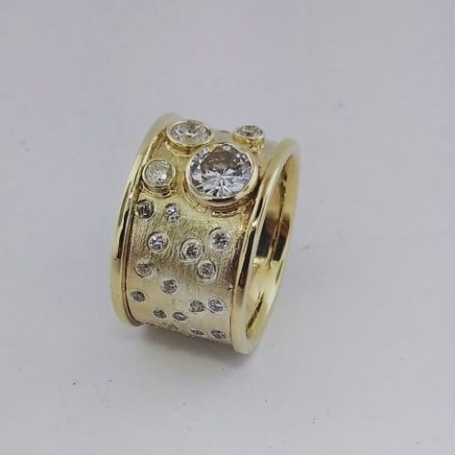 Boulder opal, tanzanite and rubies create this stately 14k rose gold ring