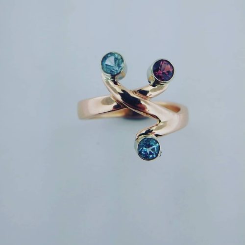 Antiqued sterling silver open band ring with emerald accents