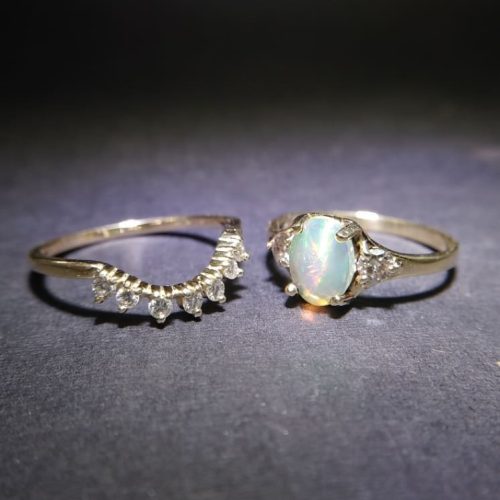 Alternating round diamond and green emerald bezel set bezel ring set in 14k yellow gold.