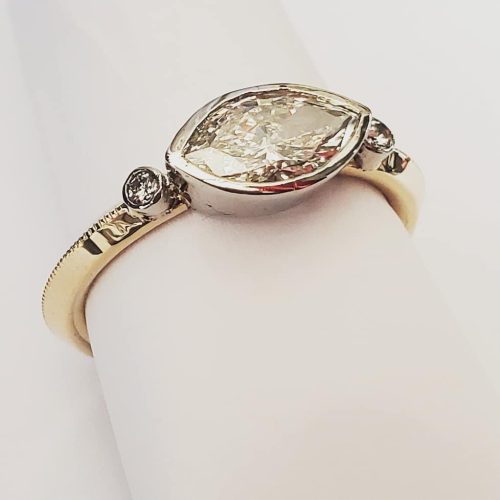 Bezel set opal ring and dangle bezel set opal earrings in 14k yellow gold.