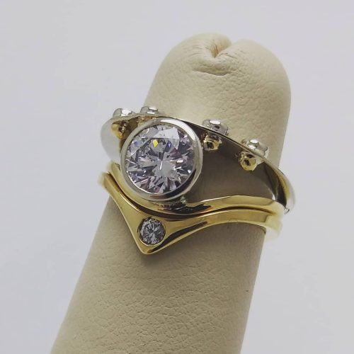 An Emerald cut London Blue Topaz set in 14k yellow gold on a sterling and 14k twist style band