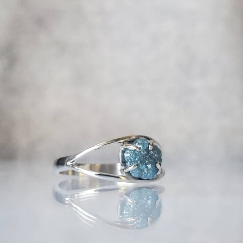 Red ruby center stone with half-moon diamonds set in 14k white gold hugged by a matte finish wedding band accented with flush set diamonds.