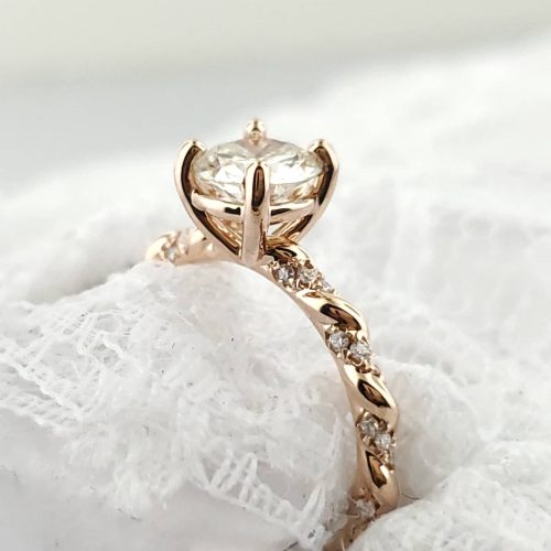 14k rose gold alternative style engagement ring set with a salt and pepper pear shape diamond and round brilliant diamond accents. Contour crown style wedding band set with a pear diamond center and diamond accented band. Made by Katherine Spencer in Morgantown, West Virginia USA