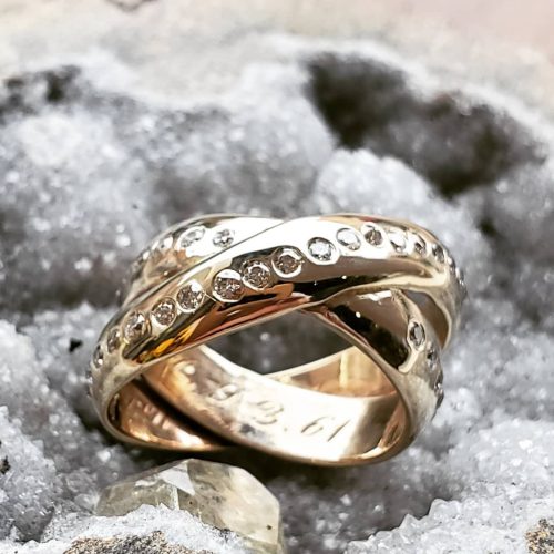 A diamond accented 14k yellow gold ring showcasing a large oval Swiss blue topaz.