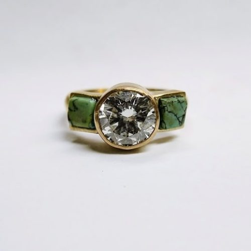 Organic opals bezel set in 14k yellow gold on a thick gold band with diamond accents.