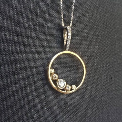 Cabochon ovals of varying color and size, bezel set in sterling silver to create a natural necklace with leaf accents.