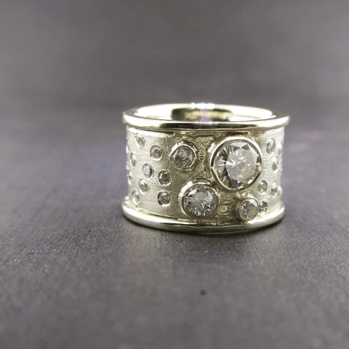 Sterling silver and 14k yellow gold open form ring set with a trillion tanzanite