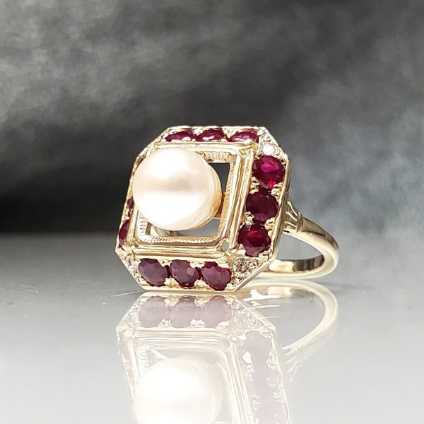 Pearl center of a red ruby octagon halo all set in 14k yellow gold.