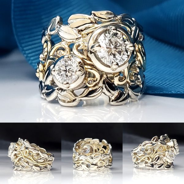 Made from 14k yellow and white gold, this leaf and accented vine band wrap around two prong set diamonds.