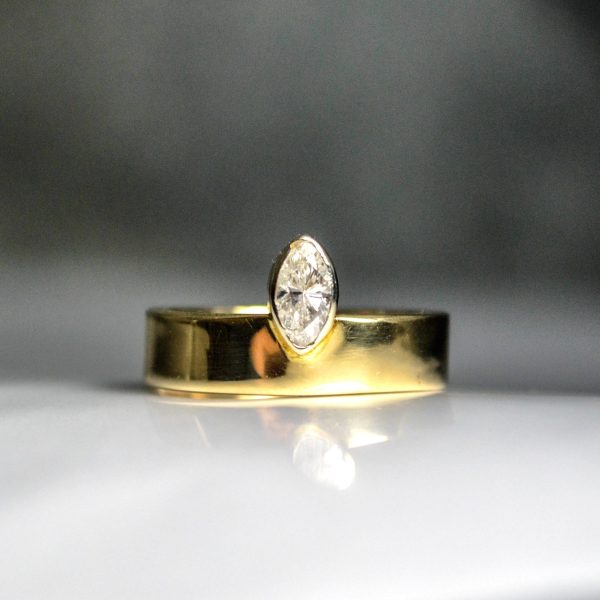 This marquise is front and center, bezel set on a solid 14k yellow gold thicker band, engagement ring. Item 1004