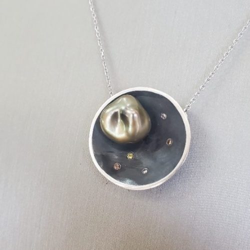 Blackened sterling silver moon pendant with diamond accents and silver pearl.