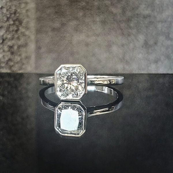 Bezel set radiant cut diamond on a delicate band in platinum Item 1005
