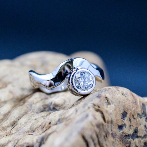 Engagement ring with a large diamond bezel set in a 14k white gold band inspired by our Country Roads Engagement Ring, alternative style. Item 8240