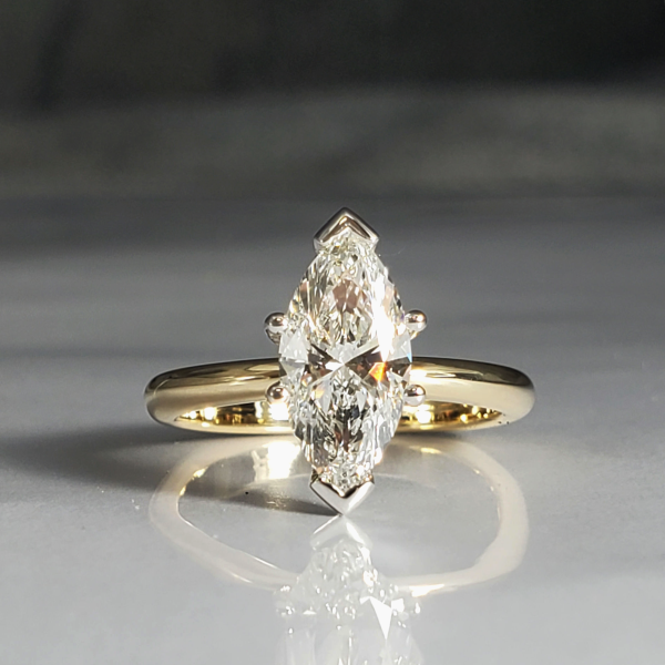 Stunning marquise cut diamond is the focal point for this solitaire 14k yellow gold ring.