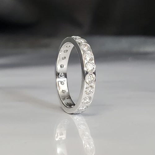 Platinum eternity wedding band with flush set round brilliant diamonds. Created by Katherine Spencer. Made in Morgantown, West Virginia USA