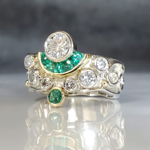 Bezel set round diamonds and green emerald wide right hand ring created in 14k white gold and 18k yellow gold. Designed and created by Katherine Spencer Made in Morgantown, West Virginia USA