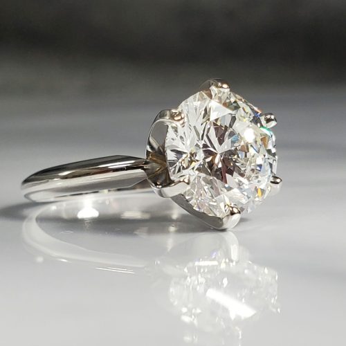 Platinum 6-prong Tiffany style solitaire engagement ring with a round brilliant diamond.